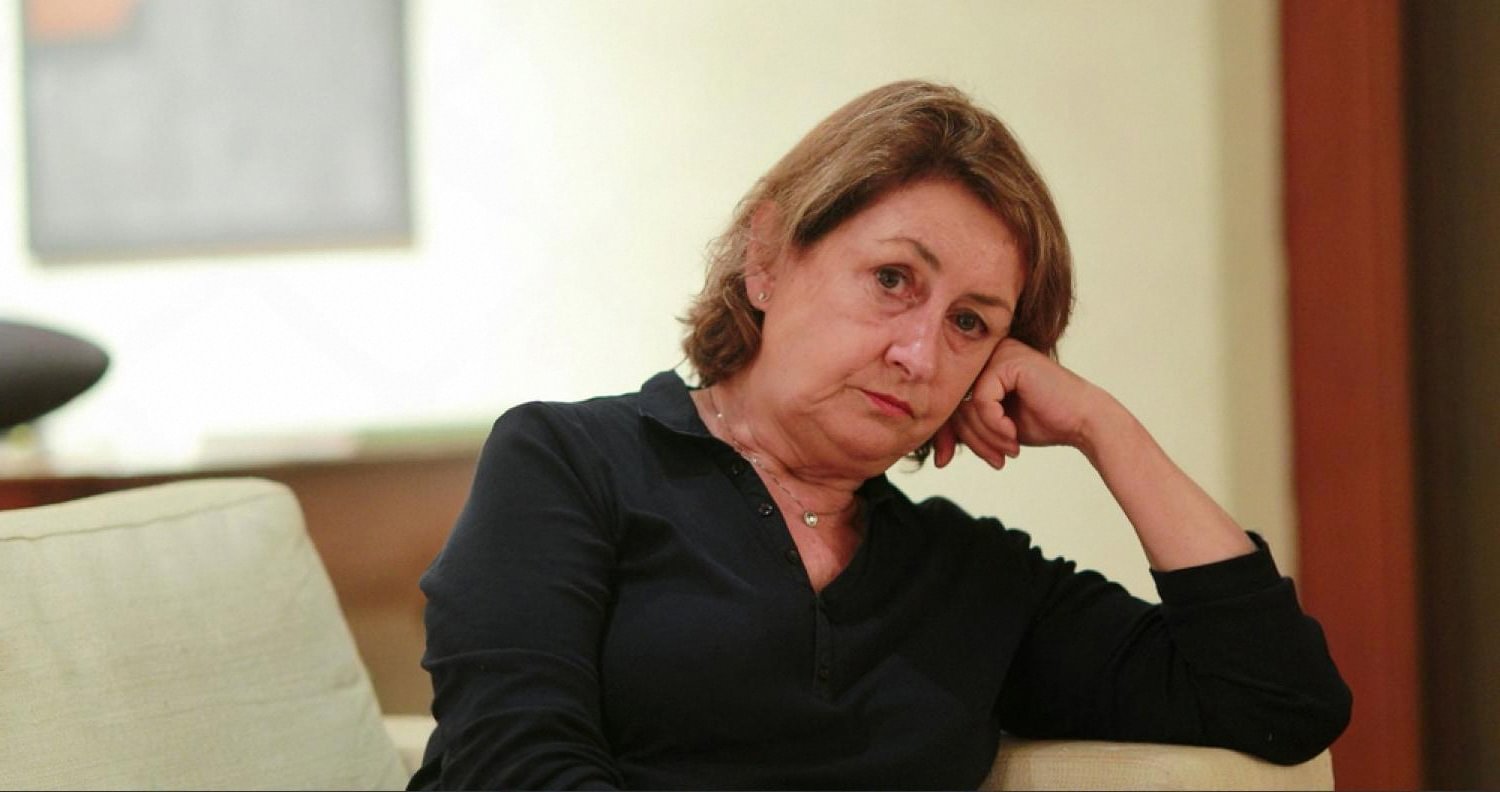 Woman sitting alone on a sofa thinking about filing for divorce in Dubai